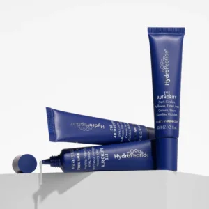 Blue HydraPeptide eye care tubes with white text, shown on a shelf; product labeled Eye Authority and Anti-Wrinkle duties visible.