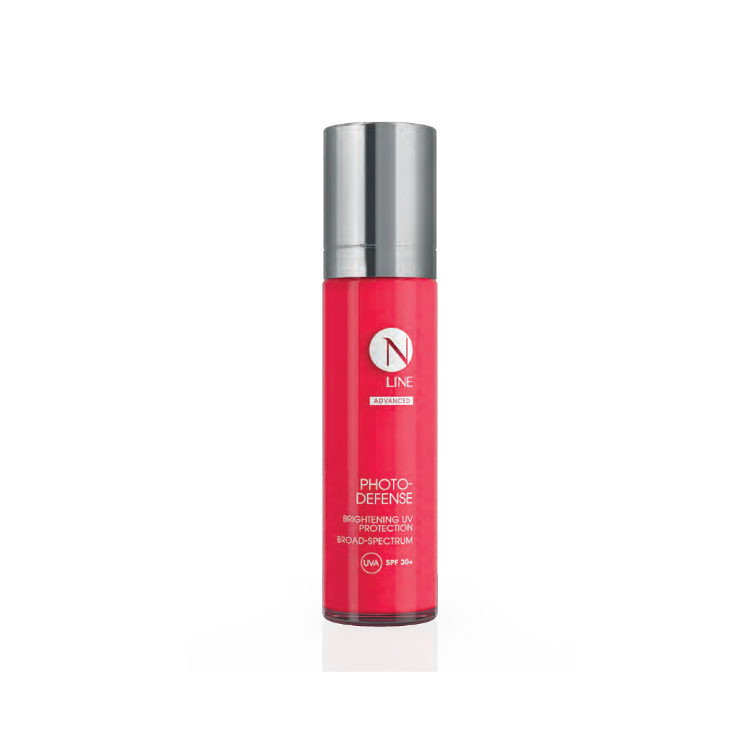 N-Line 15 - Dr Hans Clinics Bright pink bottle with a silver cap, labeled 'N LINE Photo-Defense' for broad‑spectrum UV protection (SPF 30+), standing upright on a white background.