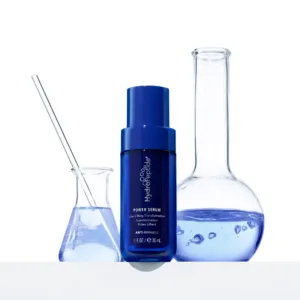 Blue bottle labeled Power Serum surrounded by laboratory glassware against a white background, suggesting a scientific skincare product.